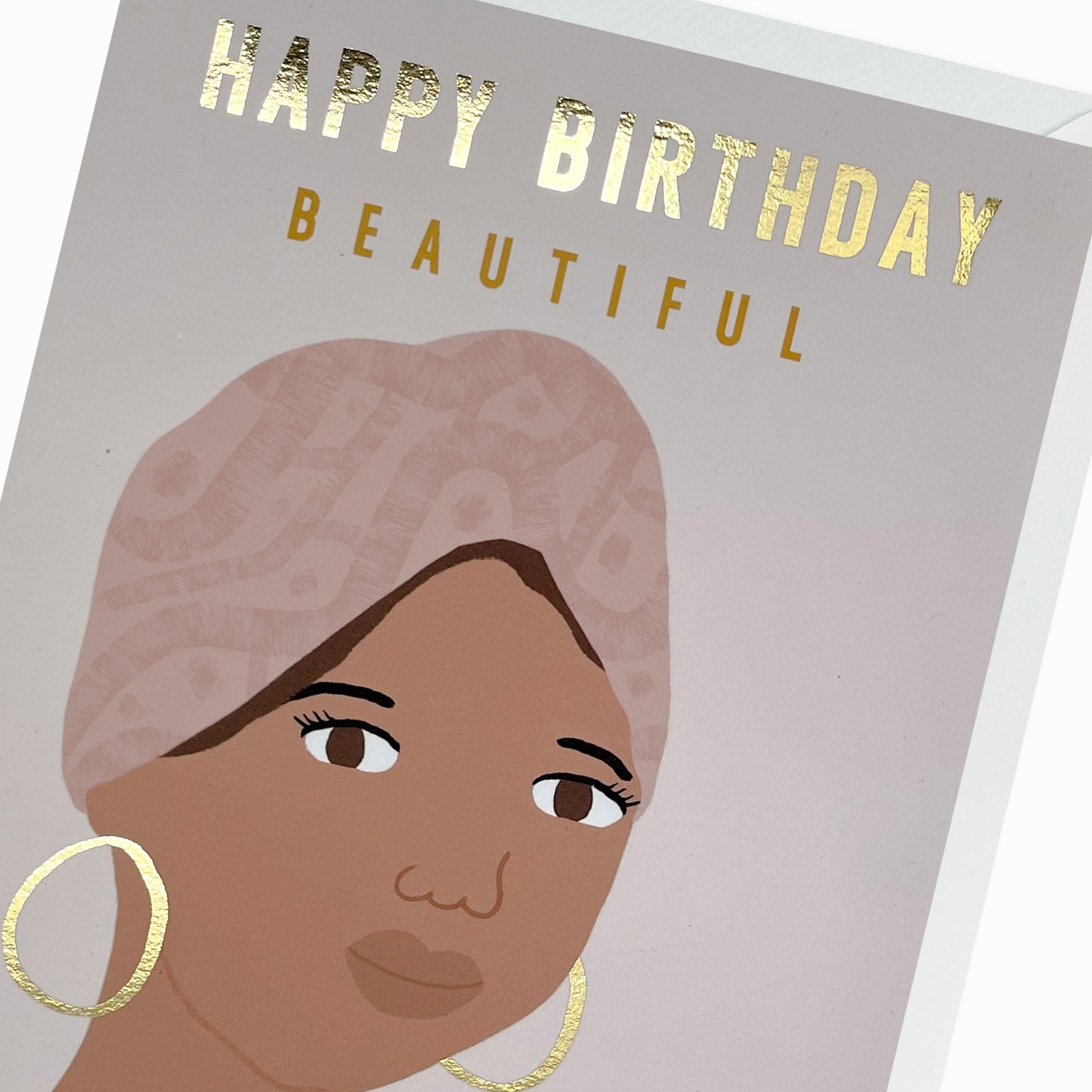 Close up of a Black and Mixed race woman, wearing a head wrap and gold hoop earrings. Black Birthday Card